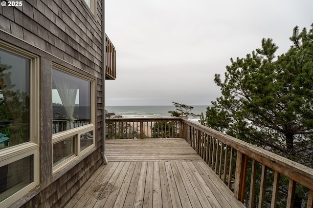 deck with a beach view and a water view