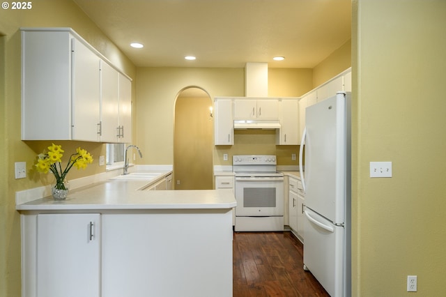 1367 Cramner St, Lafayette, OR 97127 - kitchen featuring white appliances, a sink, a peninsula, under cabinet range hood, and dark wood-style flooring
