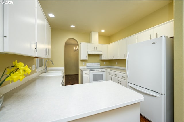 1367 Cramner St, Lafayette, OR 97127 - kitchen with white appliances, a sink, under cabinet range hood, a peninsula, and light countertops