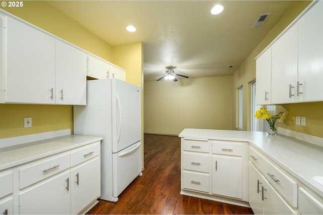 1367 Cramner St, Lafayette, OR 97127 - kitchen with freestanding refrigerator, ceiling fan, a peninsula, white cabinets, and dark wood finished floors