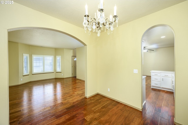 1367 Cramner St, Lafayette, OR 97127 - empty room featuring arched walkways, hardwood / wood-style floors, ceiling fan, a chandelier, and baseboards