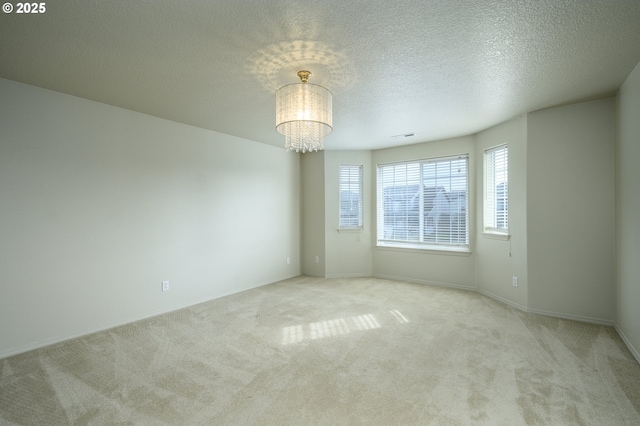 1367 Cramner St, Lafayette, OR 97127 - spare room featuring carpet floors, a chandelier, baseboards, and a textured ceiling