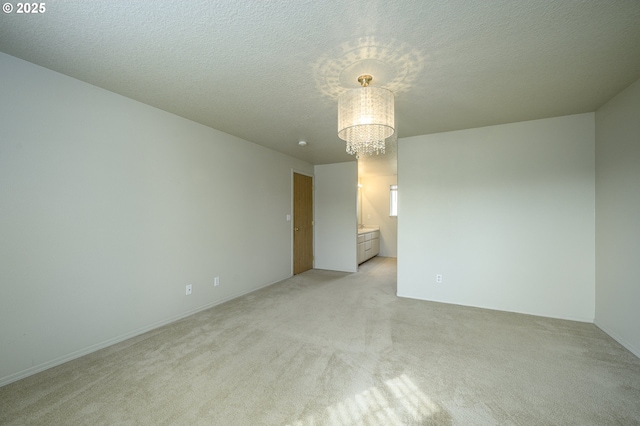 1367 Cramner St, Lafayette, OR 97127 - unfurnished room with a chandelier, light carpet, and a textured ceiling