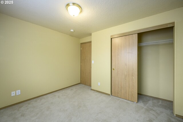 1367 Cramner St, Lafayette, OR 97127 - unfurnished bedroom with a closet, light colored carpet, baseboards, and a textured ceiling