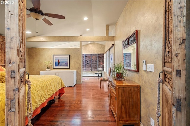 bedroom featuring wood finished floors, a textured wall, and recessed lighting