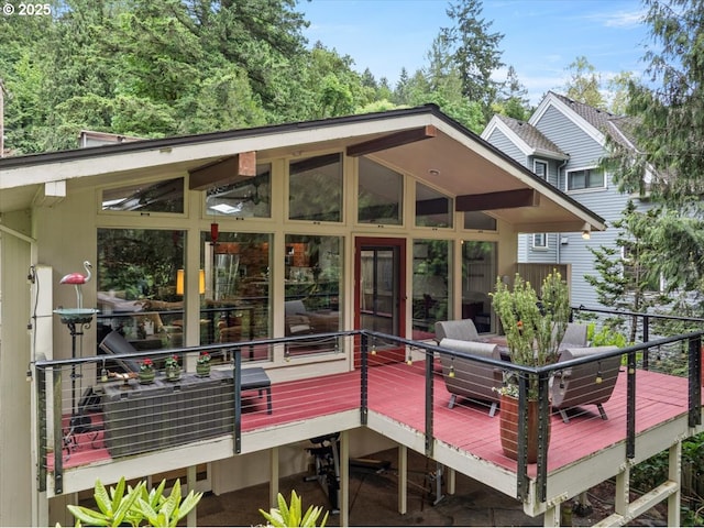 wooden deck with a sunroom