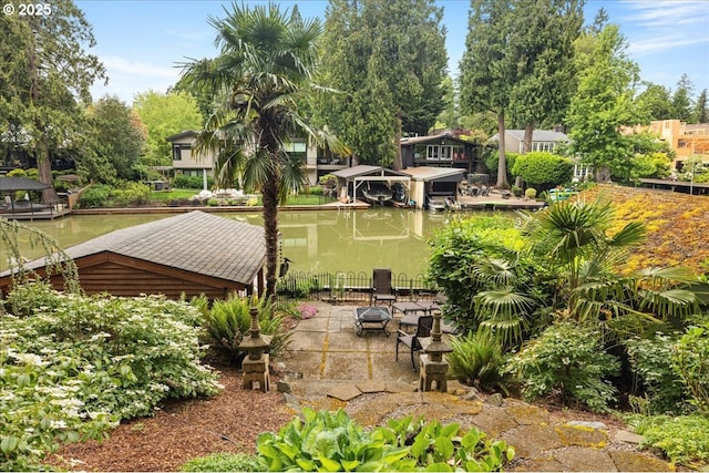 view of property's community featuring a boat dock and fence