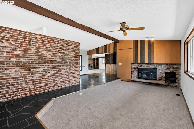 19826 NE 154th St, Brush Prairie, WA 98606 - unfurnished living room featuring ceiling fan, wooden walls, vaulted ceiling with beams, and a brick fireplace