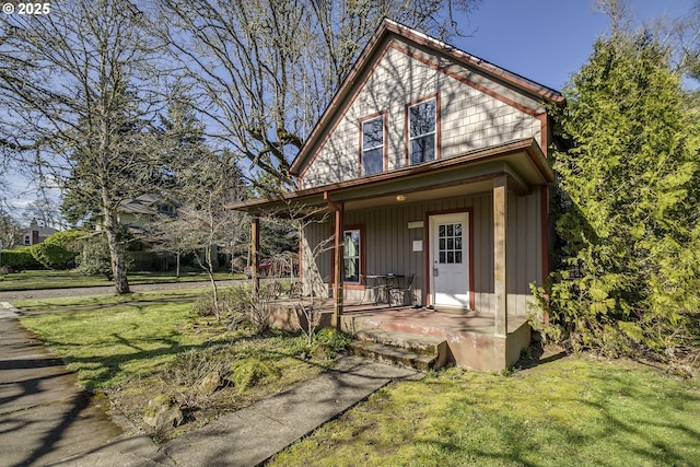 view of front facade with covered porch and a front yard