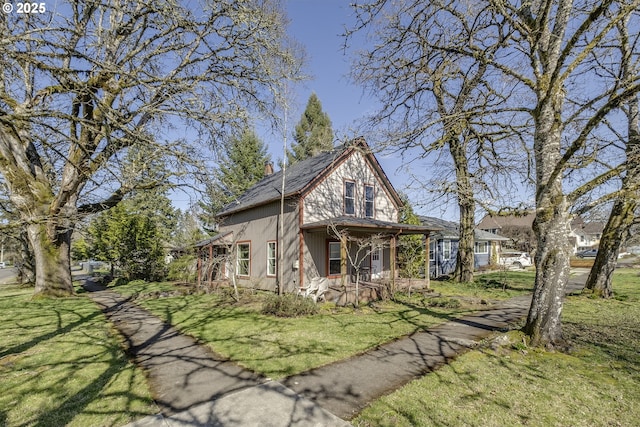 view of front of house featuring a front lawn, covered porch, and a chimney