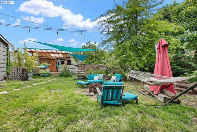 view of yard with an outdoor fire pit, a shed, and an outbuilding