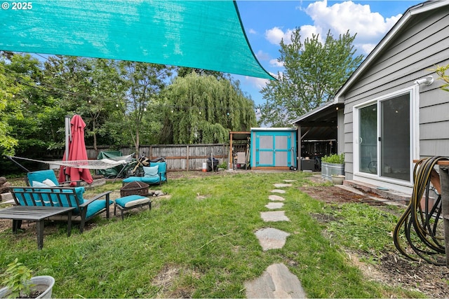 view of yard featuring a storage shed and an outdoor structure