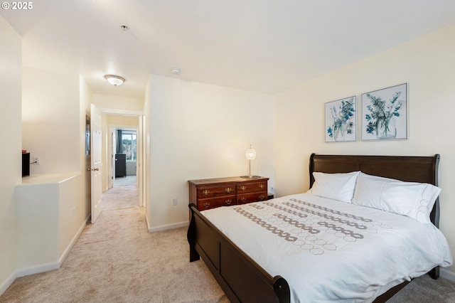 bedroom with light carpet and baseboards