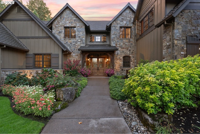 exterior entry at dusk featuring french doors