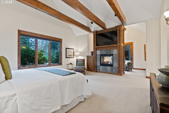 carpeted bedroom with vaulted ceiling with beams and a tile fireplace