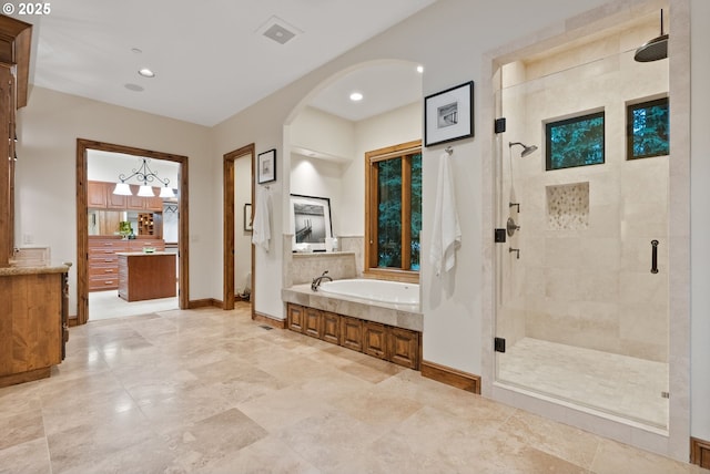 bathroom with vanity and independent shower and bath