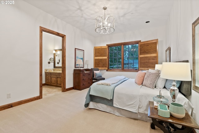 bedroom with connected bathroom, a chandelier, and light colored carpet