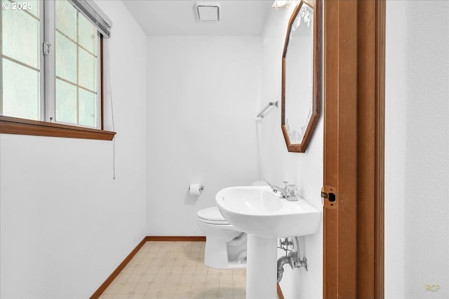 5868 NW Landing Dr, Portland, OR 97210 - half bath with tile patterned floors, baseboards, and toilet