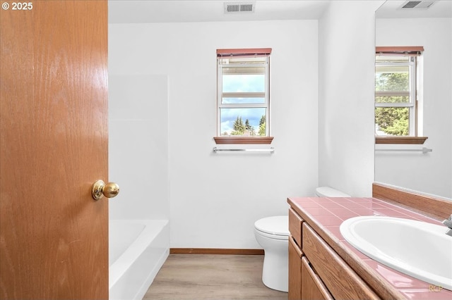 5868 NW Landing Dr, Portland, OR 97210 - bathroom featuring vanity, wood finished floors, toilet, and baseboards