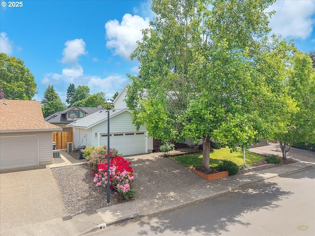 5868 NW Landing Dr, Portland, OR 97210 - view of property hidden behind natural elements with central AC unit and driveway