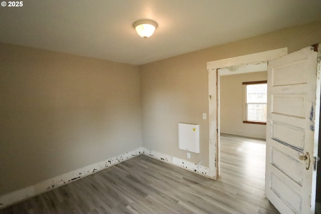 spare room featuring wood finished floors