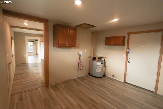 laundry area with recessed lighting, cabinet space, water heater, washer hookup, and light wood-type flooring