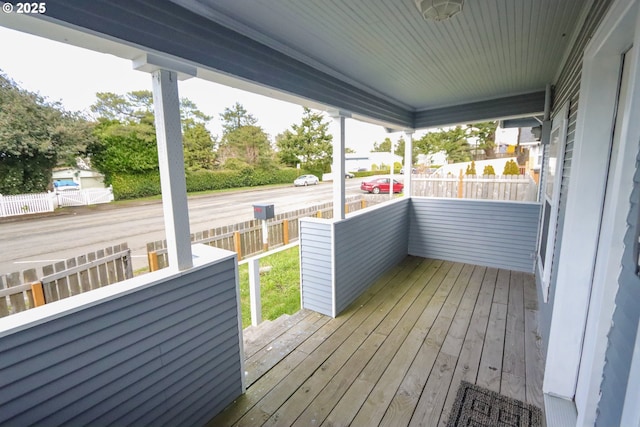 wooden terrace featuring fence