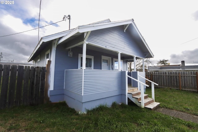 view of front of property featuring a porch and fence