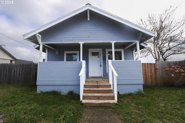 bungalow-style house featuring a porch and fence