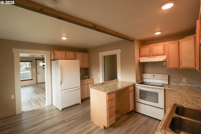 kitchen with under cabinet range hood, beamed ceiling, white appliances, and light wood finished floors