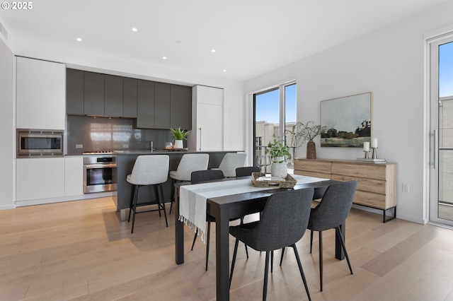1150 NW Quimby St Unit 608, Portland, OR 97209 - dining space featuring light wood finished floors and recessed lighting