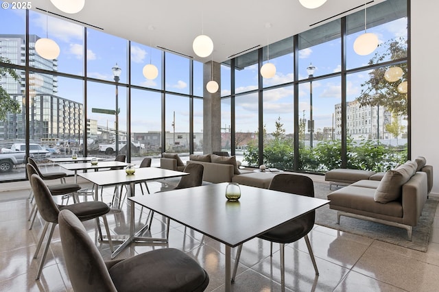 1150 NW Quimby St Unit 608, Portland, OR 97209 - dining space with floor to ceiling windows, a high ceiling, and a view of city