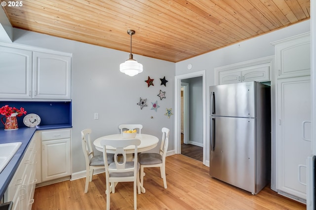 6209 SE 13th Ave, Portland, OR 97202 - dining room with wood ceiling, light wood finished floors, and baseboards