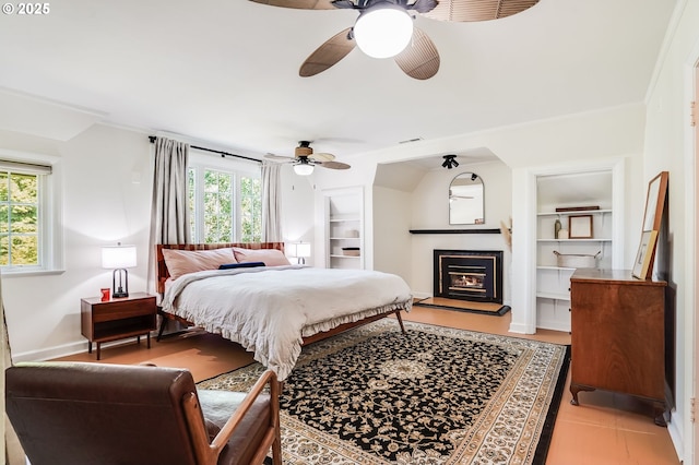 6209 SE 13th Ave, Portland, OR 97202 - bedroom featuring ceiling fan, a fireplace with raised hearth, and baseboards