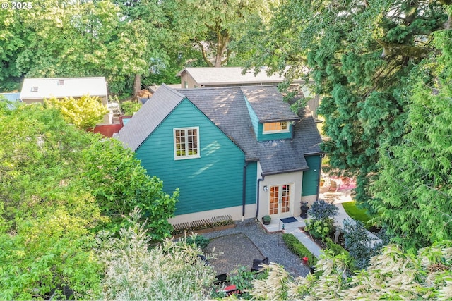 6209 SE 13th Ave, Portland, OR 97202 - view of front facade with french doors, a shingled roof, and view of wooded area