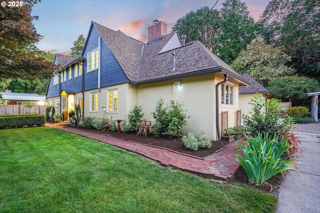 6209 SE 13th Ave, Portland, OR 97202 - view of side of property featuring stucco siding, a chimney, and a shingled roof