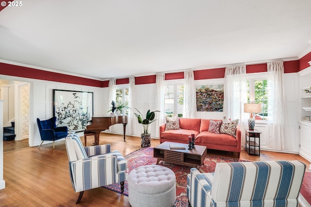 6209 SE 13th Ave, Portland, OR 97202 - living area featuring plenty of natural light, wood finished floors, stairway, and crown molding
