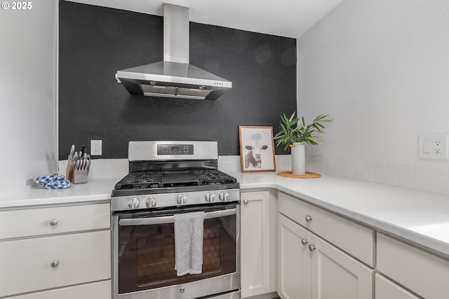 605 SE 104th Ave, Vancouver, WA 98664 - kitchen featuring gas stove, wall chimney range hood, white cabinetry, and light countertops