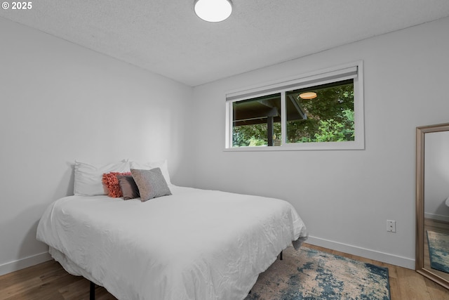 605 SE 104th Ave, Vancouver, WA 98664 - bedroom with wood finished floors and a textured ceiling