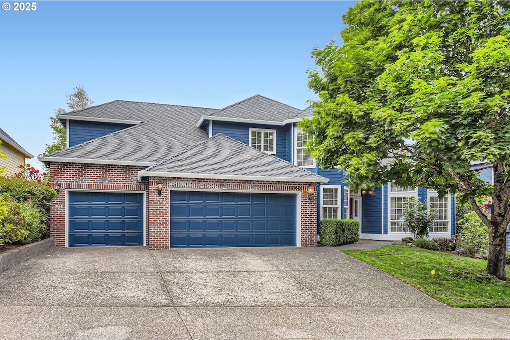 3865 NW 120th Ter, Portland, OR 97229 - traditional-style home featuring a garage, roof with shingles, concrete driveway, and brick siding