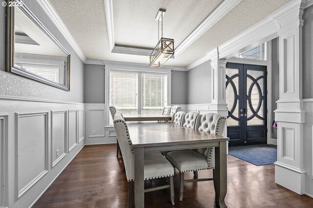 2021 Pikes Pass Ct, Salem, OR 97306 - dining area featuring a decorative wall, ornate columns, a raised ceiling, a chandelier, and ornamental molding
