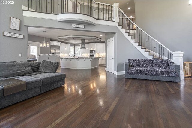 2021 Pikes Pass Ct, Salem, OR 97306 - living room featuring dark wood-style floors, stairway, a towering ceiling, and recessed lighting