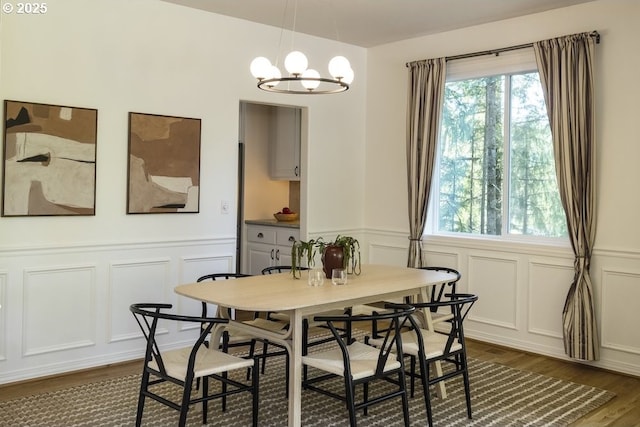 13037 SW Ascension Dr, Portland, OR 97223 - dining space with a decorative wall, dark wood-style flooring, plenty of natural light, a wainscoted wall, and a chandelier