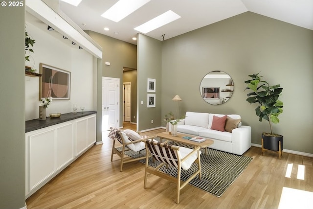 13037 SW Ascension Dr, Portland, OR 97223 - living area featuring a skylight, high vaulted ceiling, light wood-style flooring, baseboards, and recessed lighting