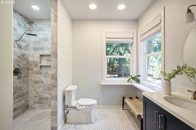 13037 SW Ascension Dr, Portland, OR 97223 - bathroom featuring vanity, tiled shower, toilet, baseboards, and recessed lighting