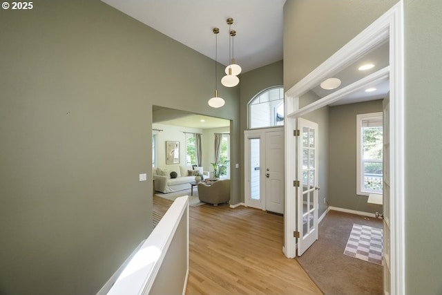 13037 SW Ascension Dr, Portland, OR 97223 - entryway with light wood-style floors, baseboards, and a towering ceiling