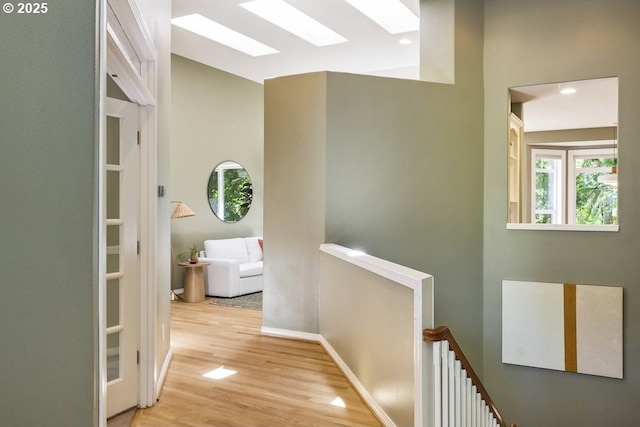 13037 SW Ascension Dr, Portland, OR 97223 - hall featuring an upstairs landing, a skylight, wood finished floors, baseboards, and recessed lighting