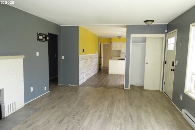 1817 Shamrock Dr, Centralia, WA 98531 - unfurnished living room with a baseboard heating unit and light wood-style flooring
