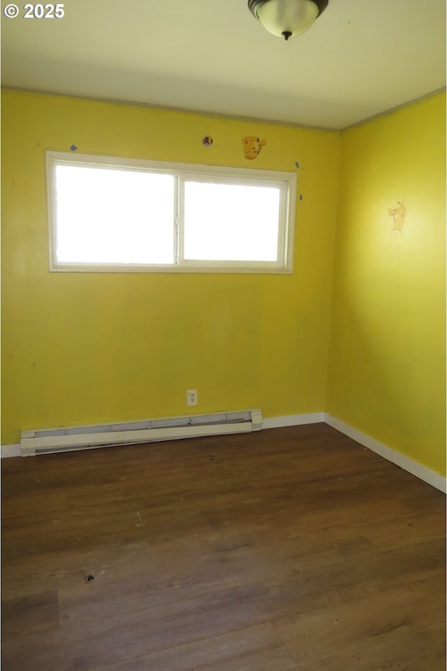 1817 Shamrock Dr, Centralia, WA 98531 - unfurnished room featuring a baseboard heating unit, wood finished floors, and baseboards