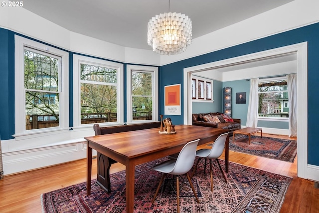 dining room with an inviting chandelier and wood finished floors